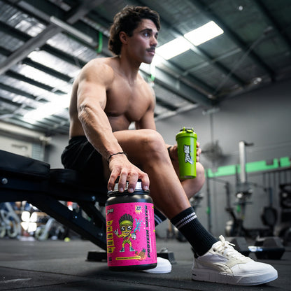 Man holding Zombie Shredz protein water at the gym