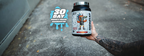 Hand holding a large tub of Zombie Labs limited edition protein powder in Caramel Biscuit flavour with a 30-day money-back guarantee graphic on the left.