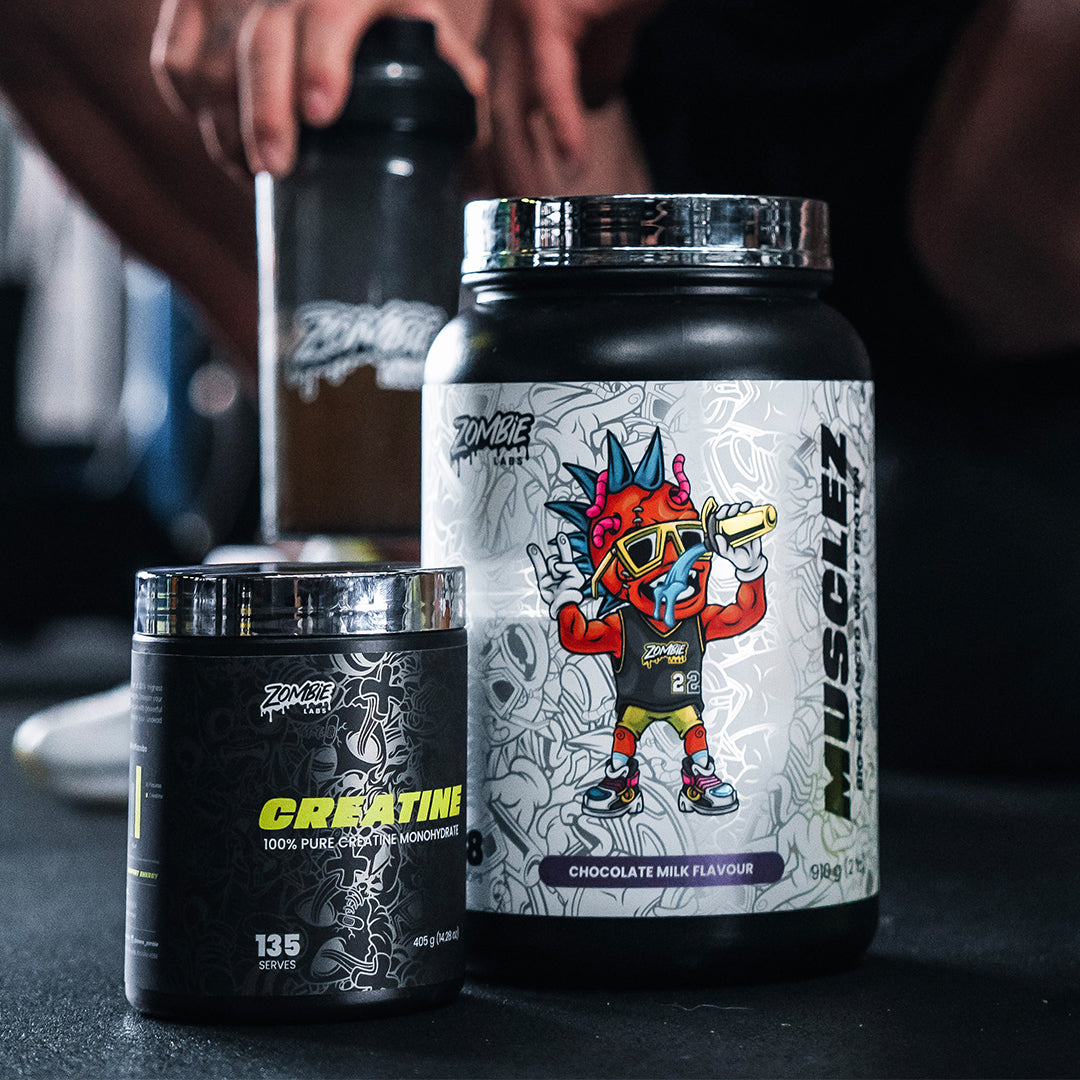 Zombie Labs Creatine tub next to Musclez Chocolate Milk flavour protein powder with man holding shaker in the background ready to mix